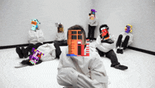 a man in a strait jacket sits in a room with a bunch of other people