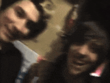 a blurry photo of two men standing next to each other
