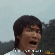 bruce lee is making a funny face while talking to khali 's breath .