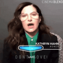 a woman wearing glasses and a green shirt says " kathryn hahn agnes " on the screen