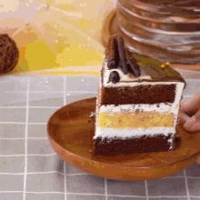 a slice of cake is on a wooden plate on a table
