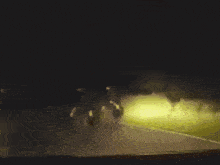a group of people are walking in the dark