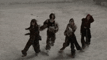 a group of women are dancing in the snow with the letters s1 on the bottom