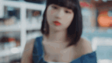 a woman with short hair is wearing a blue tank top .