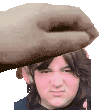 a hand is holding a man 's head in front of a pixelated face .
