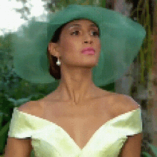 a woman wearing a green hat and a yellow dress