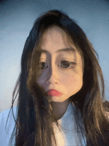 a girl with long hair making a funny face with her mouth open