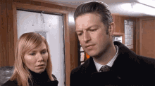 a man and a woman standing next to each other