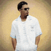 a young man wearing sunglasses and a white shirt