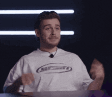 a man wearing a white shirt that says sd tech on it