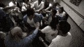 a group of people standing in a circle with their hands outstretched