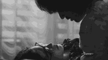 a black and white photo of a man kissing a woman with the caption " toree " above them