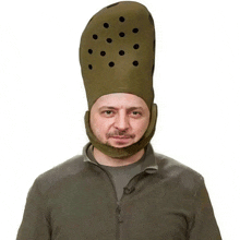 a man is wearing a very large croc hat