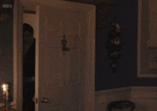 a man in a tuxedo stands in a doorway with the words " are you still up " written on the door
