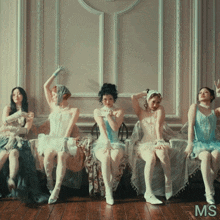 a group of women sitting next to each other with the letters ms on the bottom left