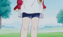 a person wearing a white shirt and blue shorts has a badge with the letter h on it