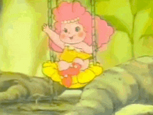 a girl with pink hair is sitting on a yellow swing