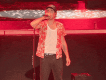 a man singing into a microphone while wearing a hat that says ' united states of america '