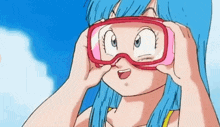 a girl with blue hair is wearing a pair of pink goggles .