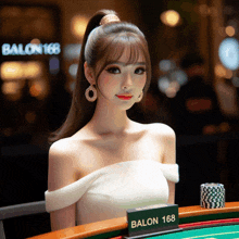 a woman sitting at a table with a sign that says balon 168 on it