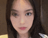 a close up of a young woman 's face with long black hair