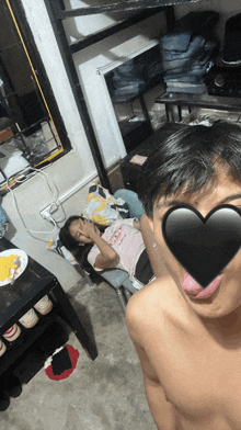 a man with a heart on his face and a woman laying on a chair