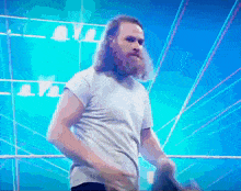 a man with long hair and a beard in a white shirt