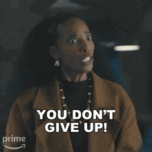 a woman says " you don 't give up " in front of an amazon arrow