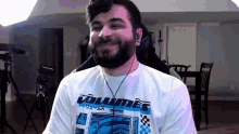 a man wearing a white shirt that says volumes
