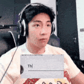 a man wearing headphones and a t-shirt that says th
