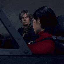 a man and a woman are sitting next to each other in a car in a video game .