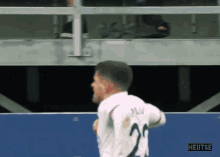 a soccer player wearing a white shirt with the number 20 on it