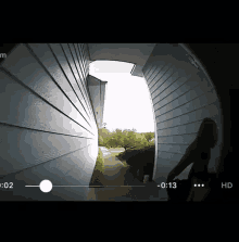 a video of a woman standing in front of a door with the time of 0 13