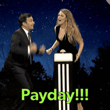 a man and a woman are dancing in front of a payday sign