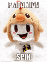 a stuffed animal wearing a chicken hat with pmdamian spin written on it