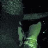 a blurry picture of a person 's face with a green light behind them