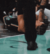 a person laying on a basketball court with a nike logo in the background