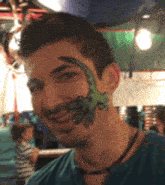 a young man with a dinosaur painted on his face