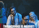 a group of people with the words this scrooge is an idiot on the bottom