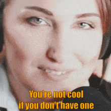 a woman wearing headphones says you 're not cool if you dont have one