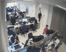 a group of people sitting at desks in an office with a time stamp of 2026-03-26 16 00:55