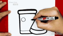 a person is drawing a cup of coffee with a zebra candy pen
