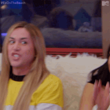 a woman in a yellow shirt is making a funny face with the hashtag #exonthe beach