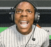 a man wearing headphones and a t-shirt that says ' l.a. ' on it