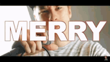 a man is singing into a microphone and the word merry is above him