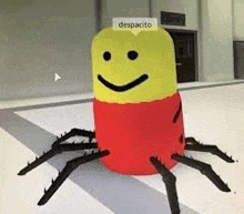 a red and yellow spider with a smiley face on it is sitting on a floor .
