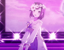 a girl wearing a flower crown is standing on a stage .