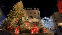 a christmas tree in front of a building that says ' boutique ' on it