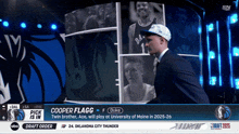 a basketball player named cooper flagg is on a basketball court