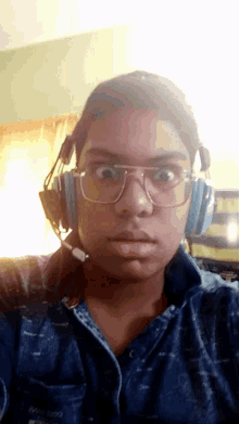 a person wearing glasses and headphones with a microphone